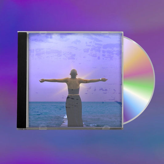 CD with cover art of a person standing in front of water under a purple sky with their soul glowing, against a blurred purple background.