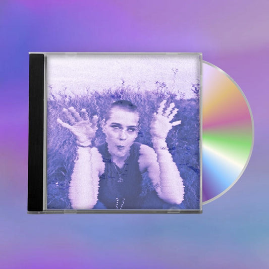 CD with cover showing a person holding up their hands on the cover against a blurred purple background